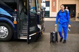 Met's player getting on the Best Trails & Travel charter bus